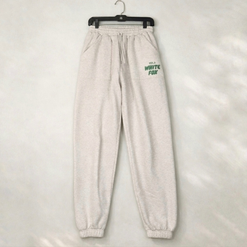 White Fox Boutique Cream Track Pants with Green Logo